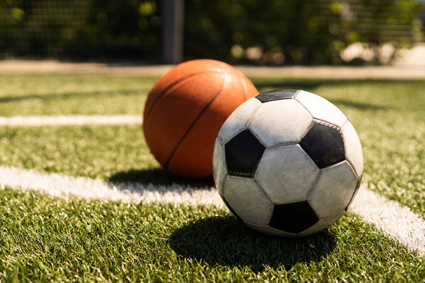 Set of sport equipment, soccer and basketball balls on green grass. - Φωτογραφία, εικόνα