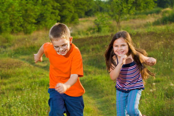 Happy children running at meadow - Photo, Image