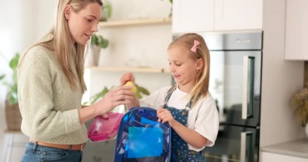 Backpack, kitchen and mother with child for school lunchbox, sandwich and healthy food for nutrition, wellness and development. Helping, support and care of a mom with her kid bag for back to school. - Footage, Video