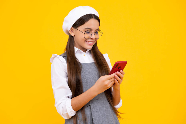 Teenage girl with smart phone. Portrait of teen child using mobile phone, cell web app. Happy face, positive and smiling emotions of teenager girl - Photo, image