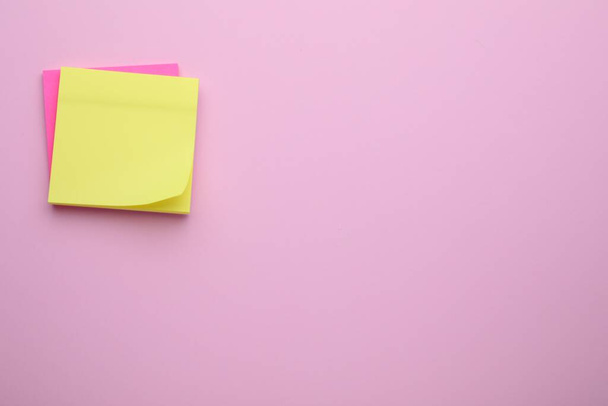 Paper notes on pale pink background, top view. Space for text - Foto, immagini