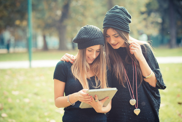 two girls  using tablet outdoors - Photo, Image