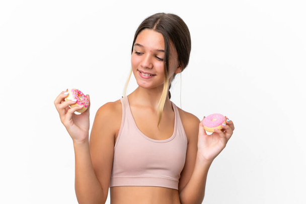 Little caucasian girl isolated on white background holding donuts with happy expression - Φωτογραφία, εικόνα