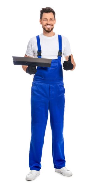 Professional worker with putty knife on white background - Foto, Imagen