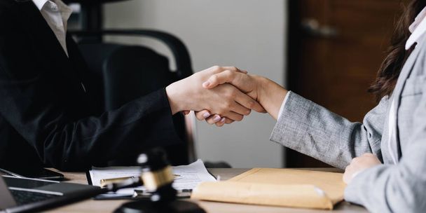 Closeup businesswoman Shaking hands with lawyer after discussing good deal in office.. - Photo, Image