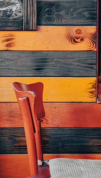 vintage wooden chair standing in front of a colorful wooden floor - Photo, Image