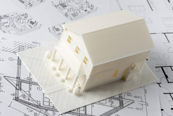 Model of the house printed on a 3D printer with white filament by FDM technology for architectural use - Photo, Image
