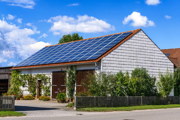 Energía verde con colectores solares en el techo de un edificio agrícola - Foto, imagen