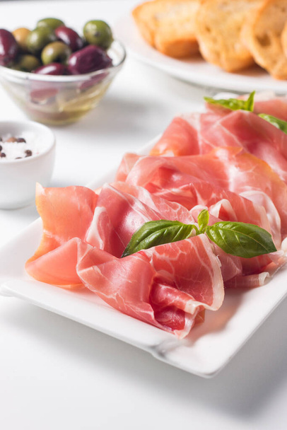 Closeup of thin slices of prosciutto. Italian food  - Foto, imagen