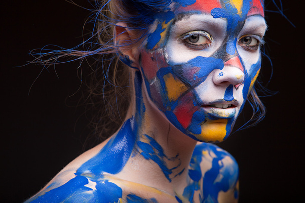 Face of a woman covered with paint - Photo, Image