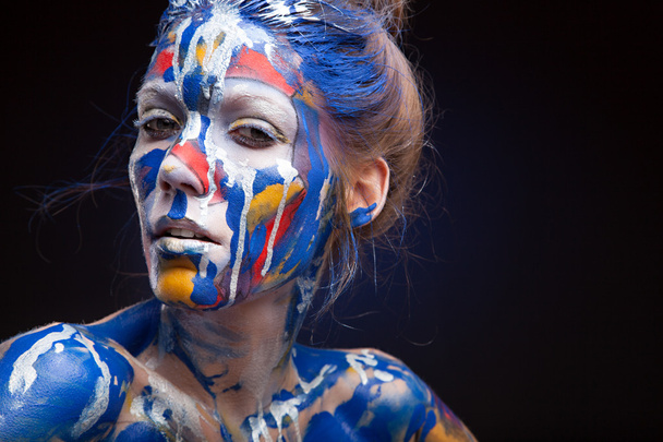 Face of a woman covered with paint - Photo, Image