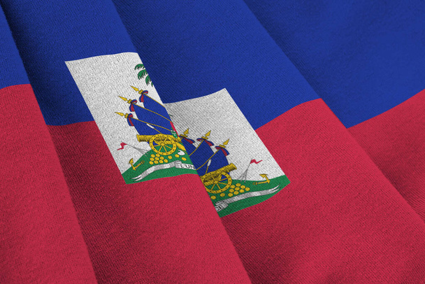 Haiti flag with big folds waving close up under the studio light indoors. The official symbols and colors in fabric banner - Photo, Image