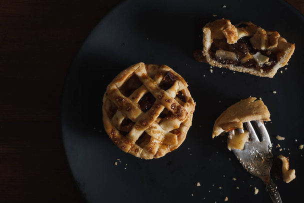 Mini Apple Pie Tarts in dark style food image. Fresh baked and home made food photo. - Foto, Bild