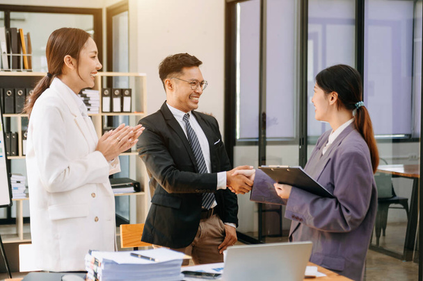 happy Asian business people shaking hands during meeting in office, success, dealing, greeting and partnership  - 写真・画像