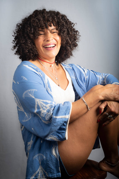 Portrait of smiling beautiful curly hair model against light background. Mature woman. Self esteem concept. - Foto, Imagem