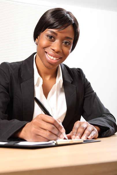Happy black business woman signing document - Zdjęcie, obraz