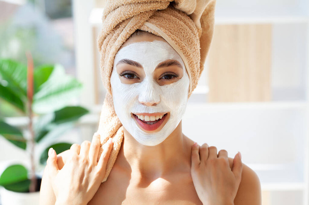 Skin care, woman with beautiful facial skin applying mask on face. - Fotoğraf, Görsel