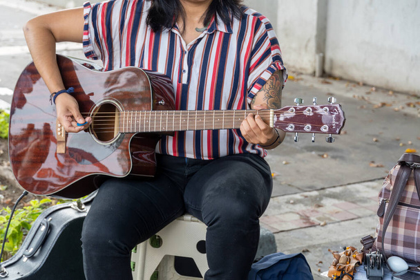 latina woman playing guitar in the street, young brunette woman, mexico, latin america, guadalajara - Zdjęcie, obraz