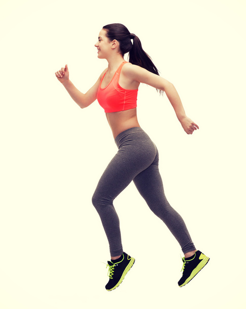 sporty woman running or jumping - Foto, Imagem