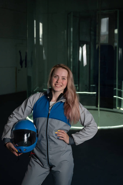 Caucasian woman puts on a helmet before flying in a wind tunnel. Free fall simulator - Photo, image