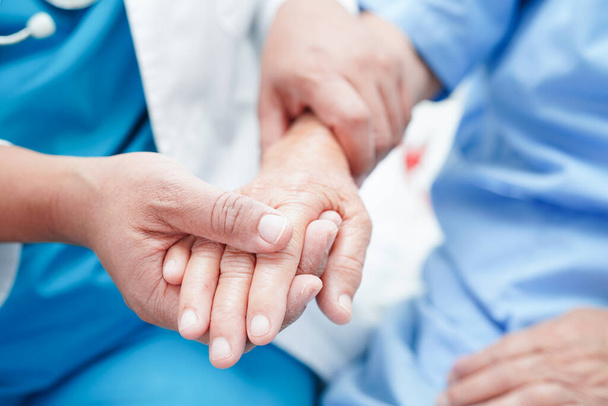 Doctor holding hands Asian elderly woman patient, help and care in hospital. - Foto, Bild