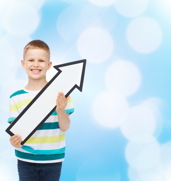 smiling little boy with blank arrow pointing right - Фото, зображення