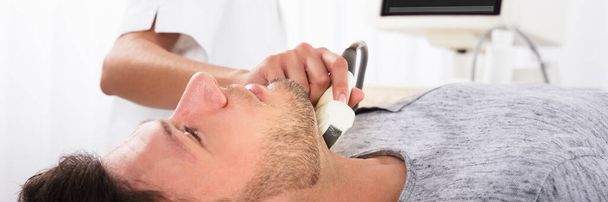 Doctor Checking Thyroid Neck With Ultrasound. Ultrasonography Machine - Фото, зображення