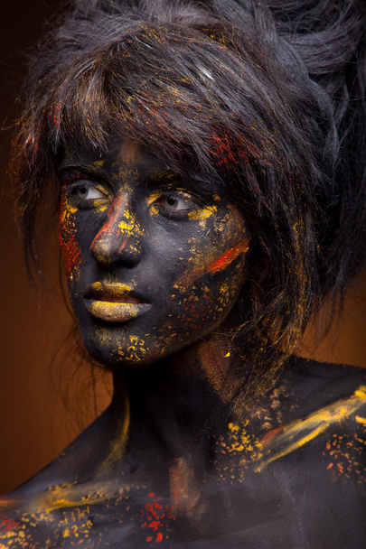 Red and yellow paint on face - Φωτογραφία, εικόνα