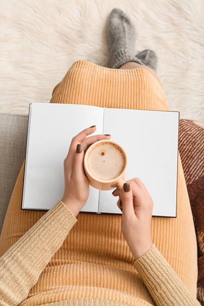 Woman with book and cup of coffee, closeup - Фото, зображення