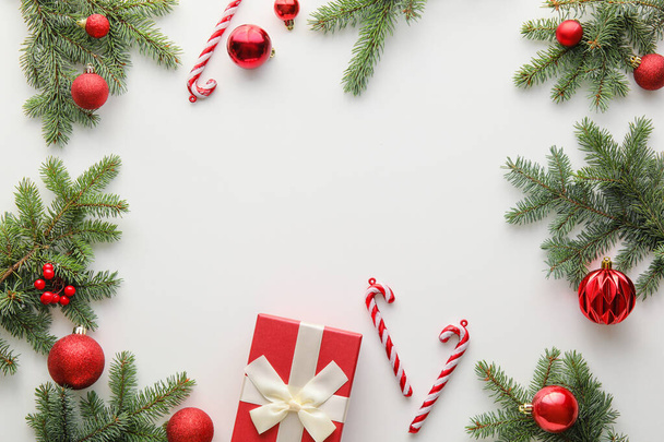 Rámeček z jedlových větví stromů a vánoční ozdoby na bílém pozadí - Fotografie, Obrázek