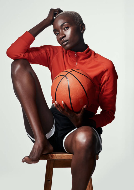 Мое время это время мяча. Студийный снимок привлекательной молодой женщины, играющей в баскетбол на сером фоне - Фото, изображение