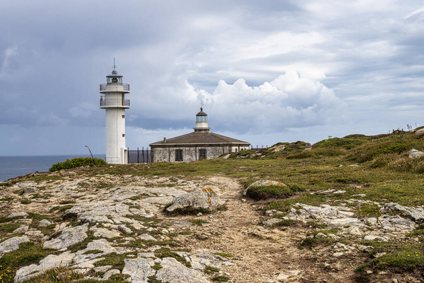 Lighthouse of cape of Tourinan in Muxia, Costa da Morte, Death Coast, Galicia, Spain. These cliffs are the westernmost coast of the Spanish peninsular territory. - Photo, Image
