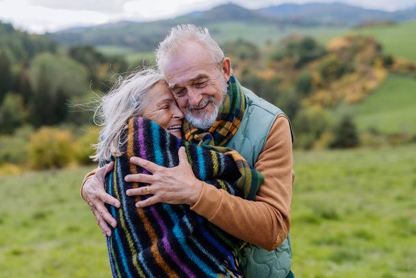 Senior couple in love huging each other in autumn forest. - Fotoğraf, Görsel