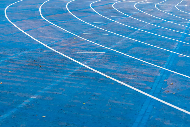 background of blue track for running competition at stadium, focus on center. - Valokuva, kuva