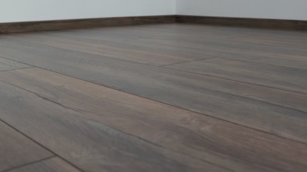 Nová laminátová podlaha. Vrstvené parkety s hnědou dřevěnou texturou - Záběry, video