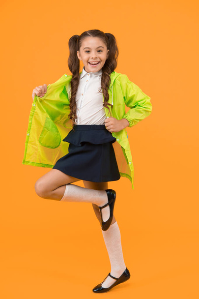 Ready to walk in any weather. Energetic schoolchild smiling on yellow background. Little girl feeling energetic back to school. Small kid getting energetic start to school year. Happy and energetic. - Fotografie, Obrázek