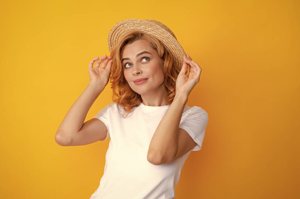 Beautiful woman in stylish straw hat on yellow background - Фото, изображение