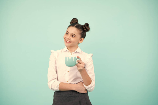 Teen girl holding coffee cup. Coffee break and recess. Teenager hold cup, drink cocoa, coffee or tea beverage - Fotó, kép
