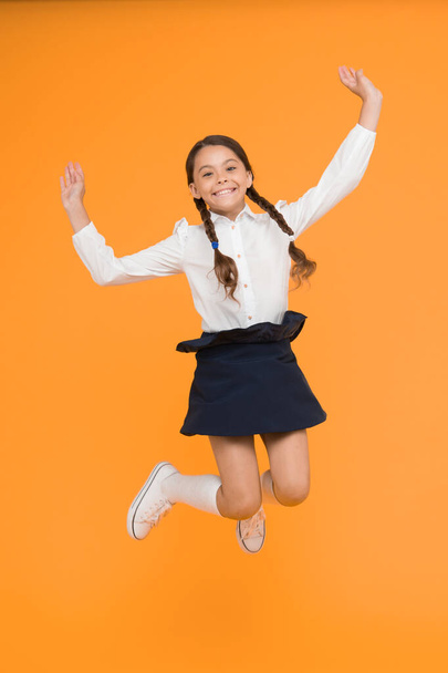 Unbridled thirst for knowledge. Girl on way to knowledge. Knowledge day. Back to school. Kid cheerful schoolgirl full of energy jump mid air. Pupil want study. Begin lesson. Active child in motion. - Foto, Imagen