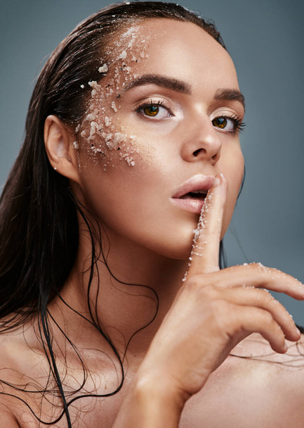 Exfoliating is my secret. a beautiful young woman posing with salt on her face - Photo, Image
