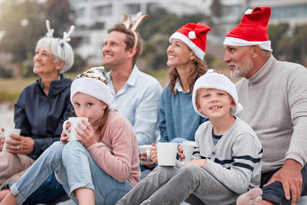 Happy, big family and relax for Christmas holiday, bonding and quality time together in the outdoors. Parents, grandparents and kids with drink in family celebration for December, festive or new year. - Photo, Image