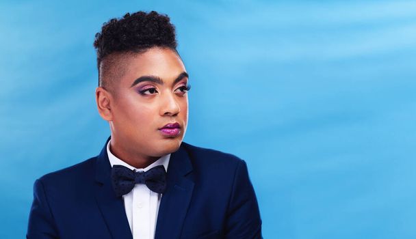 Your style is a reflection of who you are. a gender fluid young businessman posing against a blue background - Photo, Image