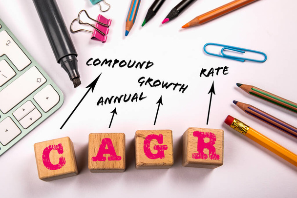 CAGR - Compound Annual Growth. Office supplies on a white table. - Photo, Image