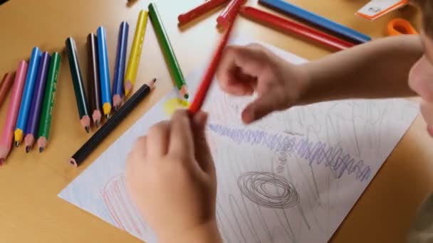 boy drawing, illustration on paper, boy drawing on paper with colorful pencil - Footage, Video