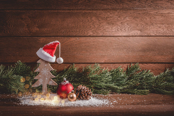 メリークリスマス。木製の背景に木製のクリスマスの装飾やモミの枝 - 写真・画像
