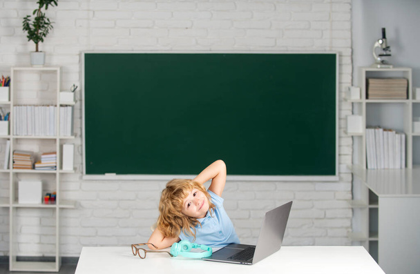 Back to school. Boy student learning online in class. Kid study online video call with zoom. Pupil child learn english language online with laptop at school - Foto, Bild