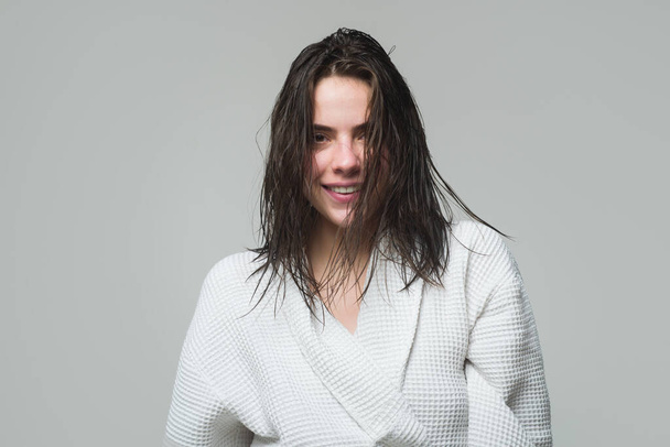 Happy smiling young woman portrait in bathrobe. Morning female model with wet hair. Hair care and beauty. Morning routine - Foto, Imagen