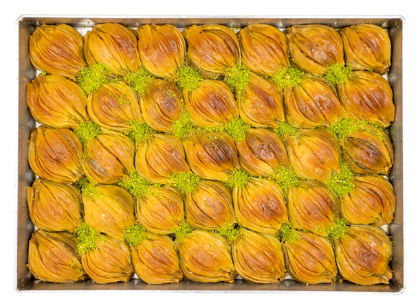Mussel baklava with pistachio on tray isolated on white background. Turkish cuisine. Close-up. local name tepsi midye baklava - Zdjęcie, obraz