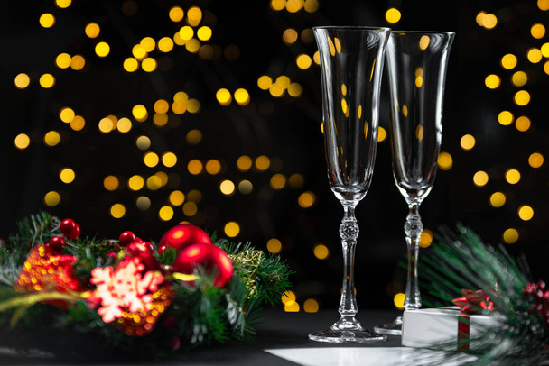 New Years Eve 2022. Champagne glass with bokeh lights on dark background. - Foto, Bild