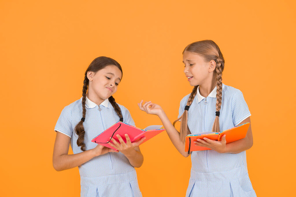 Reading books. Reading and retelling. Small children holding books yellow background. Sincere interest. Little girls with encyclopedia or childrens books. School library. Educational books for school. - Foto, Imagem